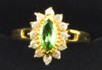 A tsavorite garnet surrounded by diamonds in a ring